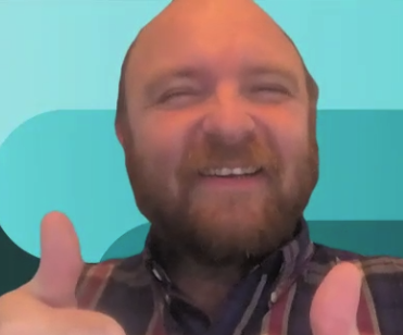 Me with a giant smile giving two thumbs up for office-culture-day.